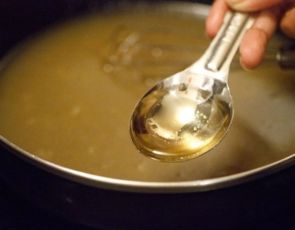 vinegar being added to eggless applesauce cake recipe.