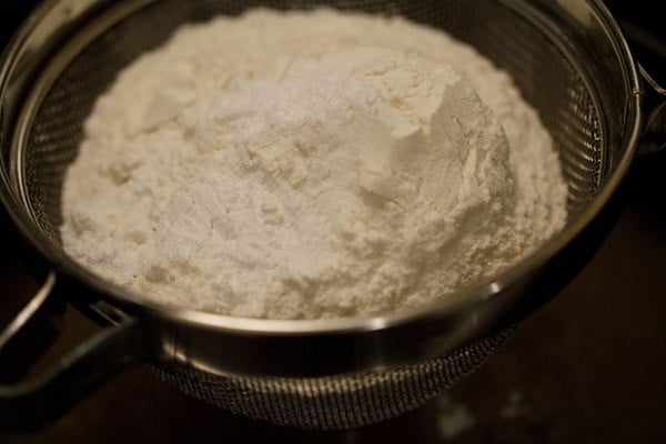 adding dry ingredients for eggless applesauce cake recipe.