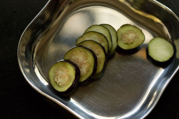 sliced brinjals in a squared steel plate