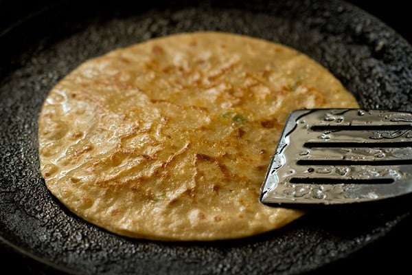 roasting cheese paratha on tawa