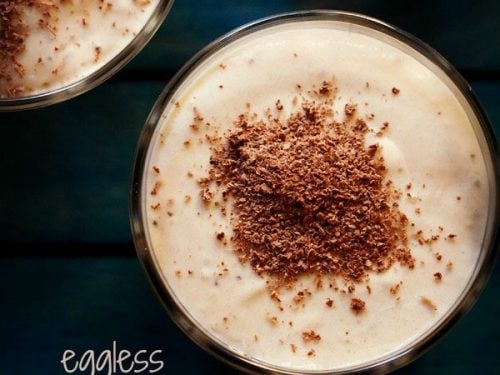 overhead shot of banana mousse garnished with grated chocolate and served in glass bowls with text layovers.
