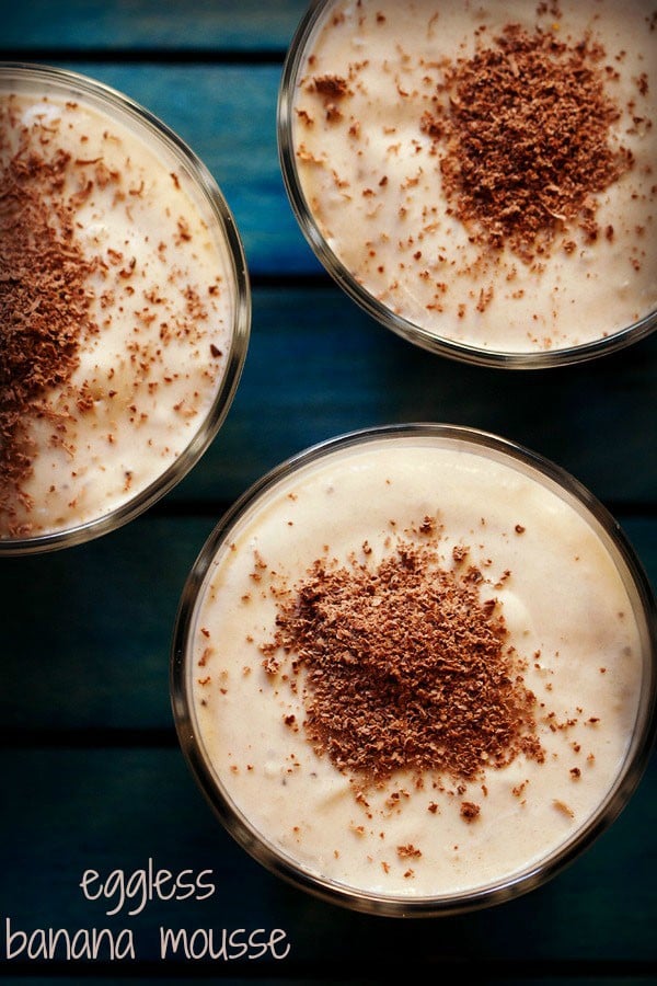 overhead shot of banana mousse garnished with grated chocolate and served in glass bowls with text layovers.