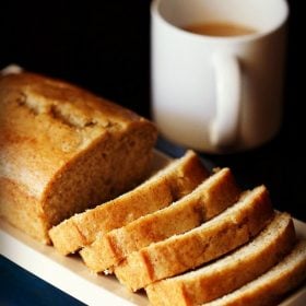 applesauce cake loaf with slices on white tray