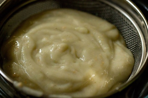 straining blended guava pulp through a strainer. 