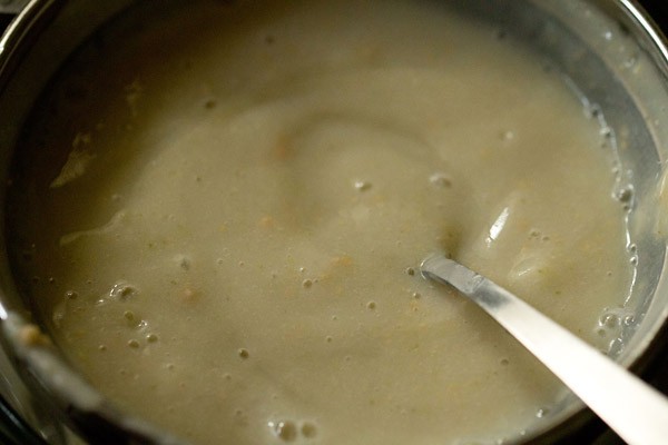 straining blended guava pulp through a strainer. 