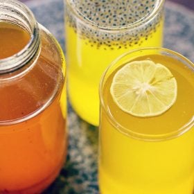 lemon squash drink served in glasses with a jar of lemon squash syrup at the side