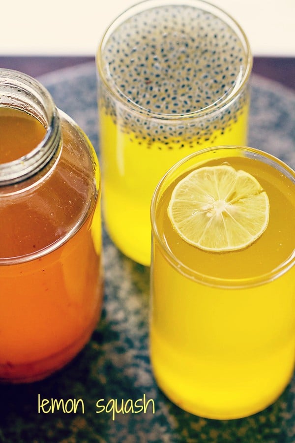 lemon squash drink served in glasses with a jar of lemon squash syrup at the side