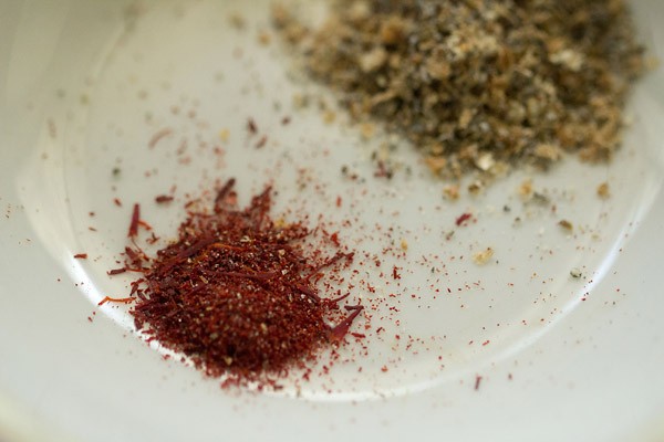 powdering green cardamom seeds and saffron for lemon squash