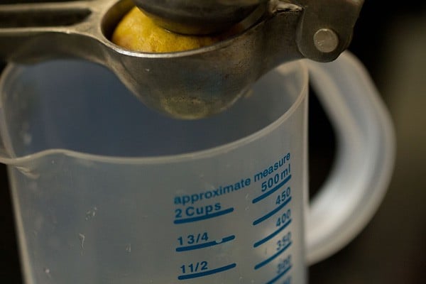 extracting lemon juice in mug