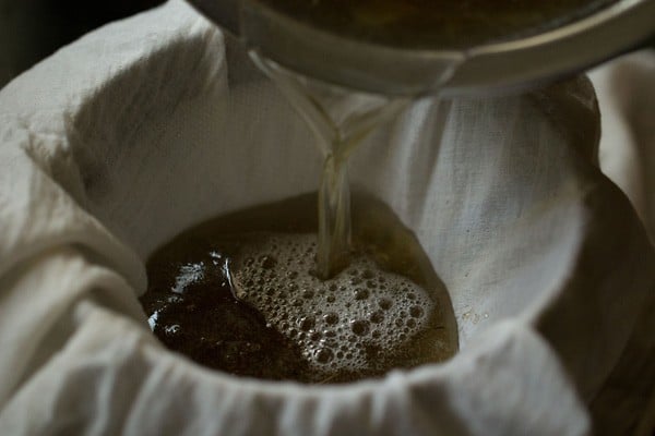 pouring sugar solution through muslin lined strainer 