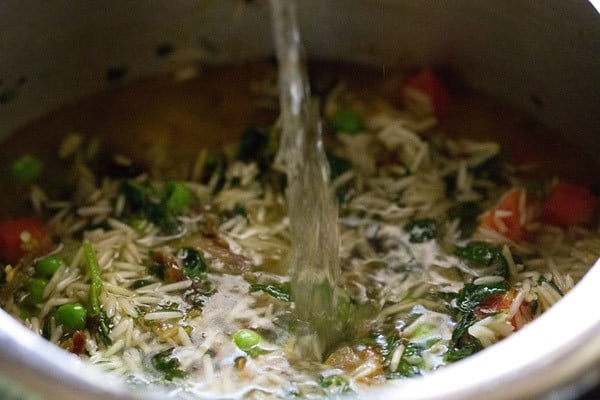 water added to methi rice mixture in pressure cooker