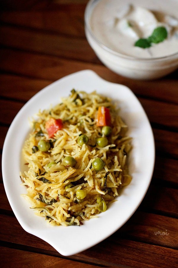 methi rice served in a plate with a bowl of potato raita