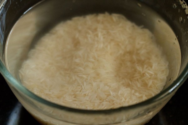 soaking basmati rice in water in glass bowl