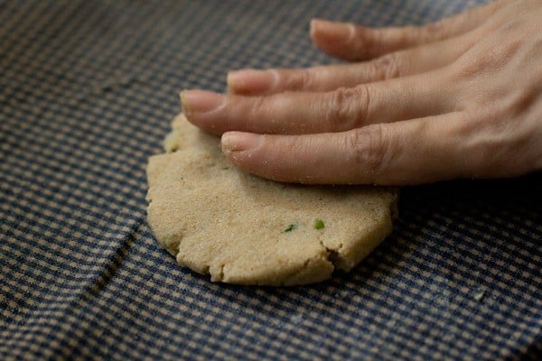 flattening rajgira paratha dough ball with hands