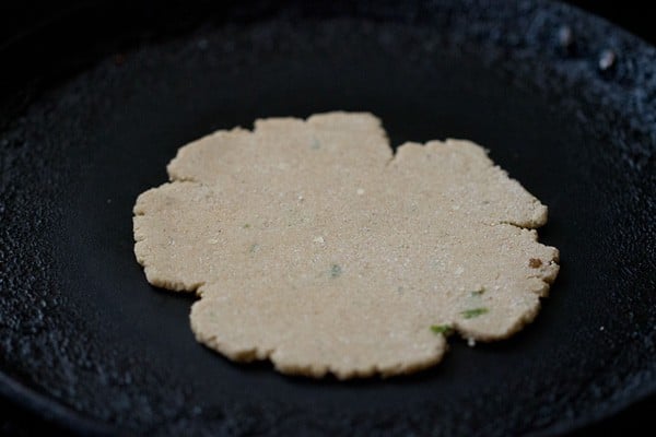 frying amaranth paratha on skillet