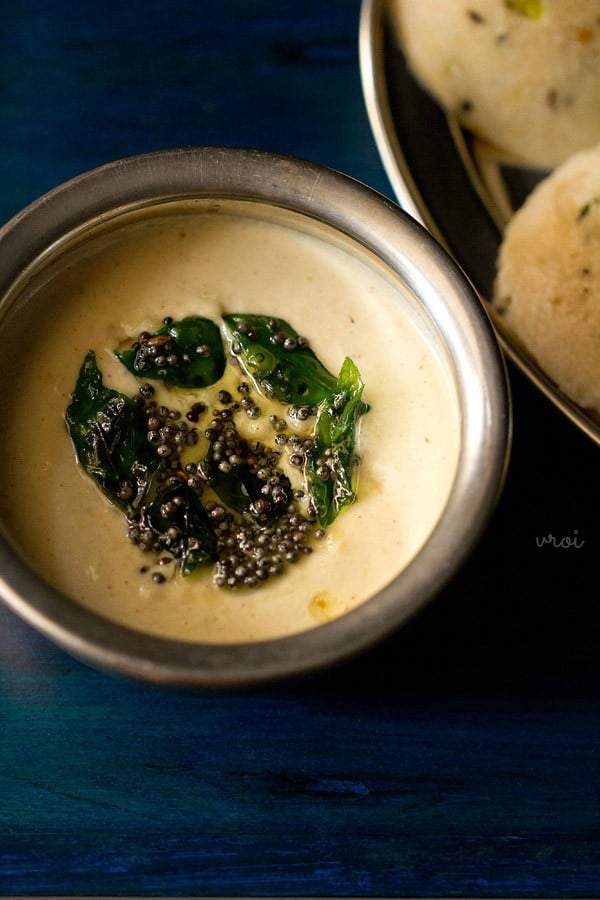 dal chutney served in a steel bowl with the tempered ingredients in the center.