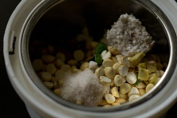 roasted chana dal, grated fresh coconut, chopped ginger, chopped green chilies and salt added to a grinder jar.