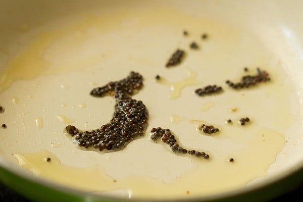 mustard seeds crackling in hot oil for tempering.