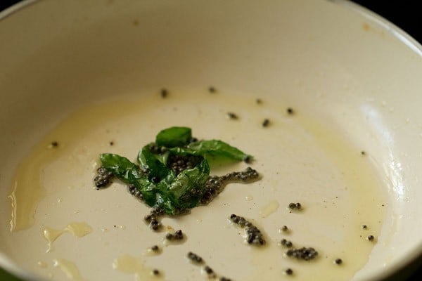 sautéing curry leaves till crisp.