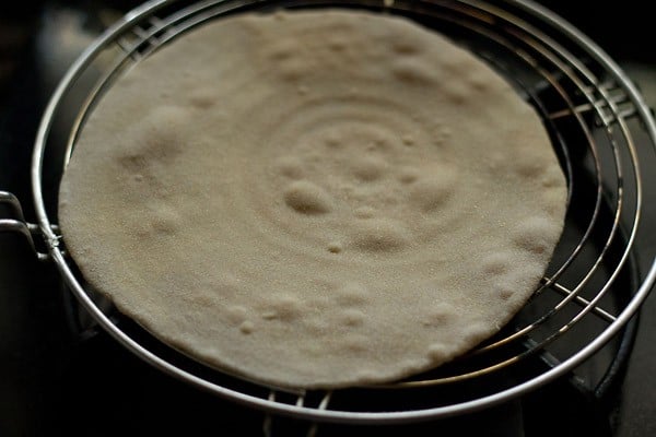 making butter roti on rack - the bubbles in this method are much smaller.