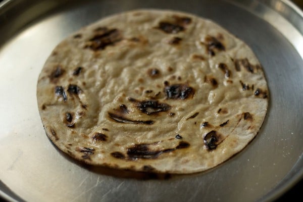 tandoori roti has been spread evenly with melted butter.