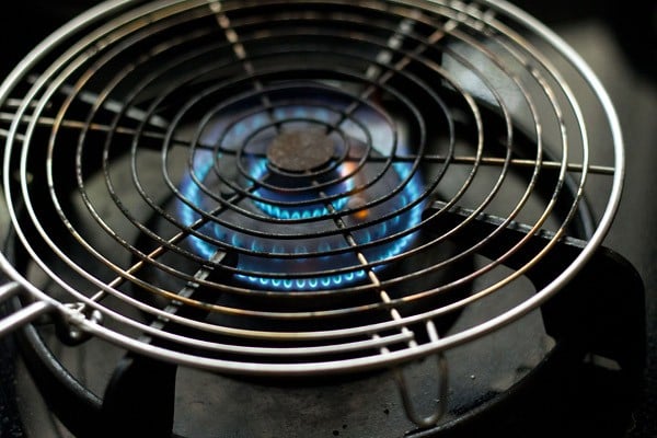 circular wire rack over the flame of a stovetop.