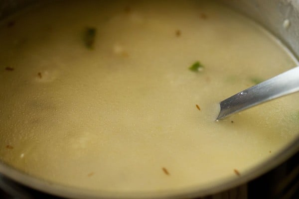 stir and checking samvat rice khichdi at intervals