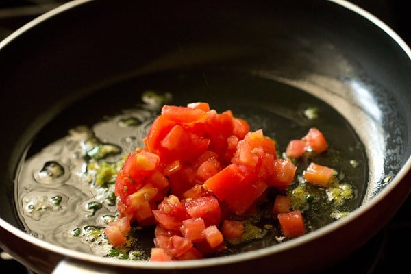 tomatoes added to aromatics in pan