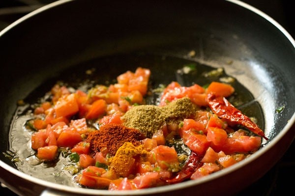ground spices added with tomato, chile and ginger mix
