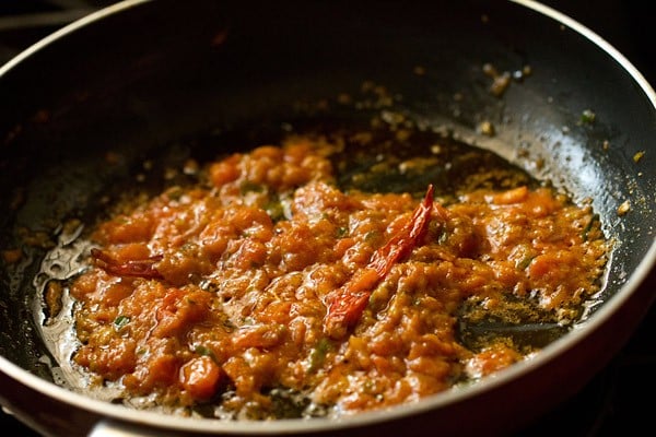 tomatoes are beginning to turn pulpy in the pan while making achari gravy