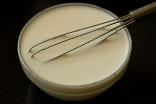 bowl of fresh curd with a whisk