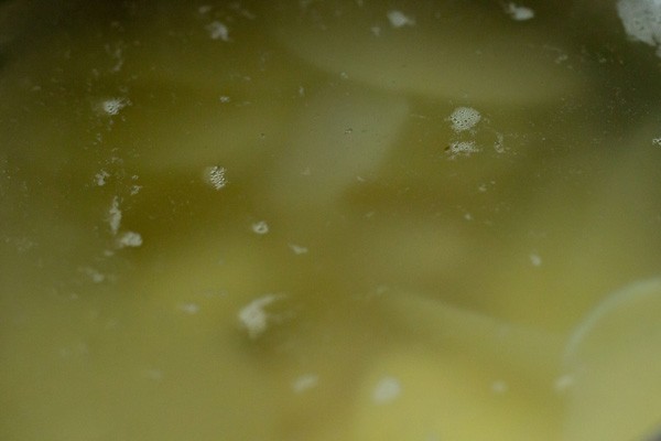 blanching potatoes in starchy water.