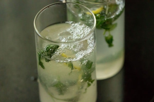 pouring soda in each glass. 