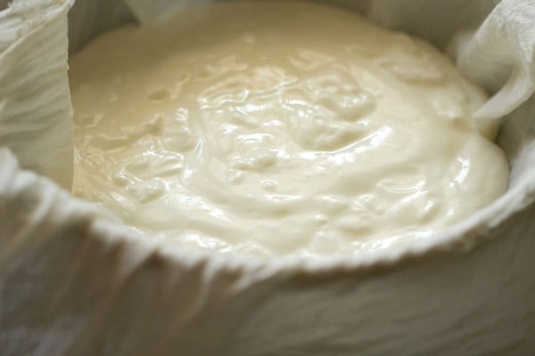 fresh curd or yogurt poured in the muslin cloth to make greek yogurt.