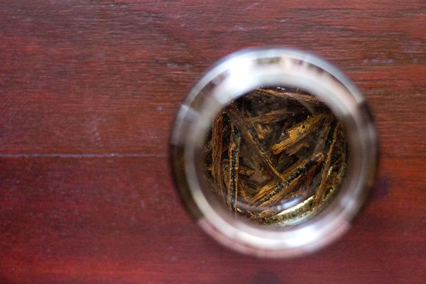 overhead shot of vanilla beans steeping in vodka for making homemade vanilla extract.