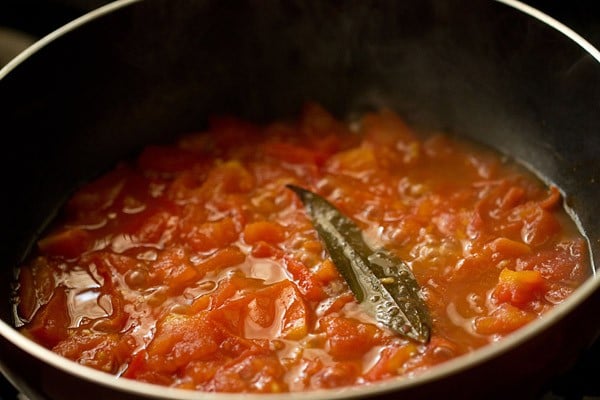 sauteing tomatoes in the pan