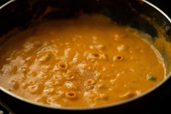 sugar added and simmering kaju curry