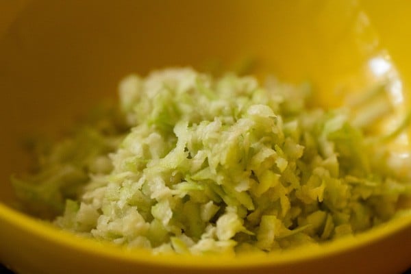 grated lauki in a yellow bowl