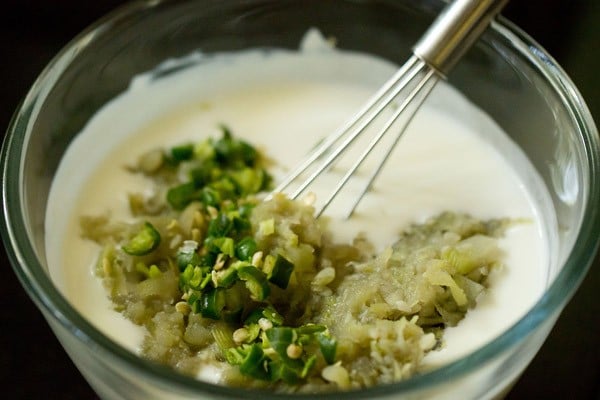 cooked lauki, chopped green chillies added to curd 