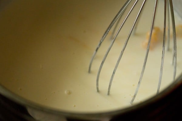 whisking in the cheese until it melts entirely with no clumps. 