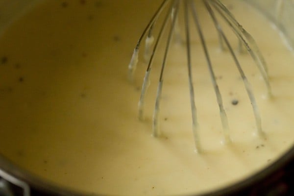 whisking the sauce for mac and cheese.