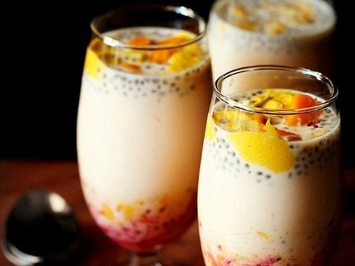 mango falooda served in three glasses with spoons kept on the side.