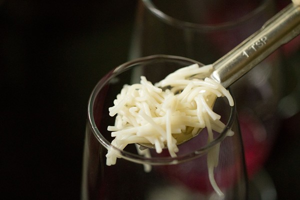 cooked falooda sev added in serving glass. 