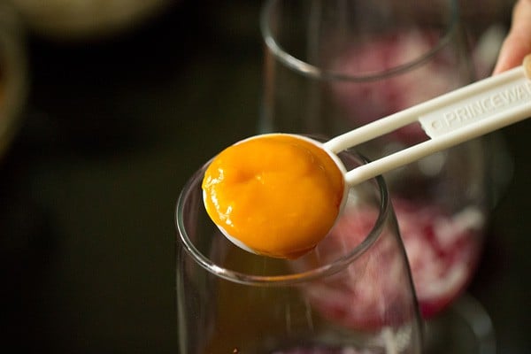mango puree added in the serving glass. 