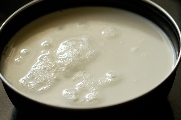 Add milk to a heavy bottomed pan to make milk rava kesari. 