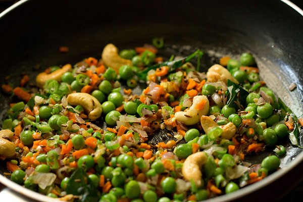 vegetable mixture being sautéed in saucepan