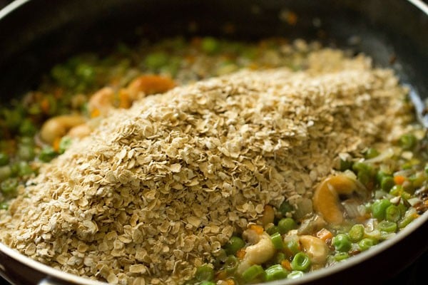 roasted oats added on top of vegetable mixture in saucepan