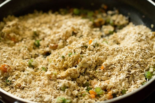 oat and vegetable mixture being combined in saucepan