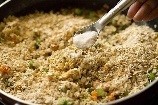 salt being added with a measuring spoon