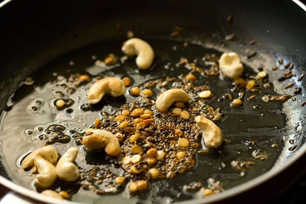 frying spices, lentils in saucepan